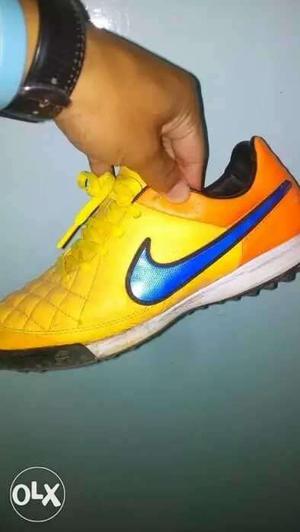 Unpaired Yellow And Blue Nike Cleats