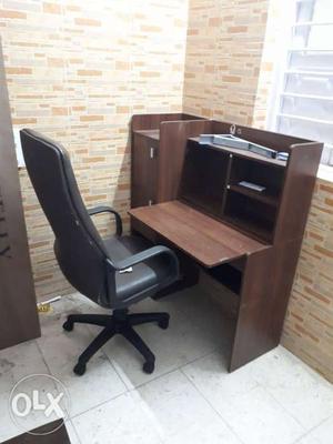 Brown Wooden Office Desk With Black Rolling Armchair