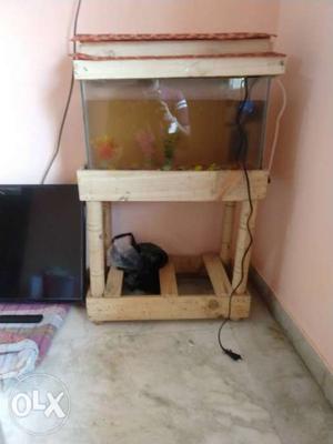 Fish tank. wooden stand. and oxygen machine. only