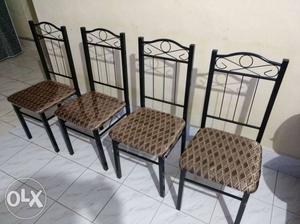 Four Black Metal Framed Padded Chairs