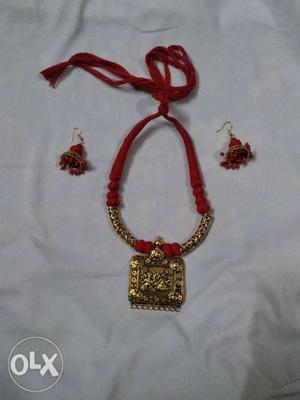 Red And Gold-colored Pendant Necklace