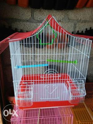 White colour cage with red roof