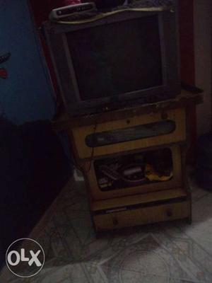 Black and grey TV with wooden table