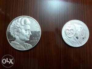 Silver coin embedded with images of Mahatma
