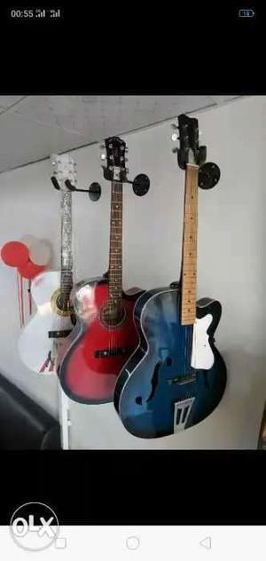 Two Blue And Red Acoustic Guitars