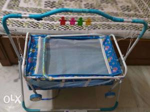 Blue and white baby cradle