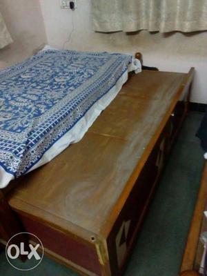 Brown Wooden Bed Frame With Blue Bed Sheet