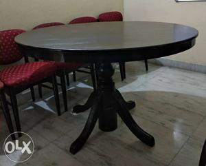 Wooden brown round dining table with six wooden