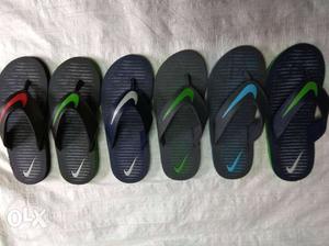 Four Pairs Of Black And Green Flip Flops