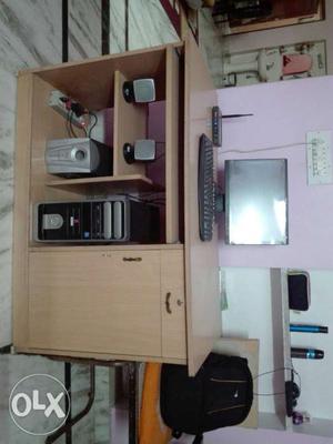 A LCD computer system along with wooden table,