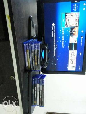 Black Sony PS4 Game Console With Game Cases