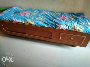Brown Wooden Bed Frame With Blue And Green Floral Mattress