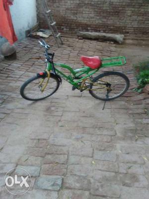 Green And Black Bicycle With Training Wheels