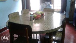 Oval shaped dining table with glossy sunmica and