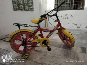 Red And Yellow Bike With Training Wheel