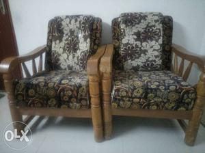Two Brown Wooden Framed Gray Floral Padded Armchairs