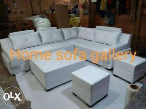 White leathrite Sofa With decent cushion + table & 2 puffy