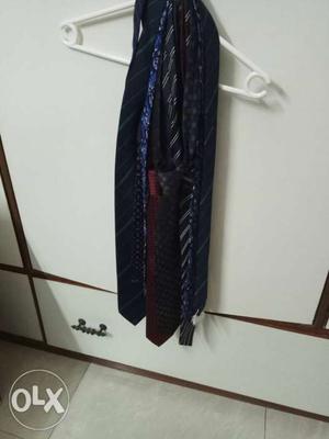 Bunch of 8 branded silk ties of different colors.