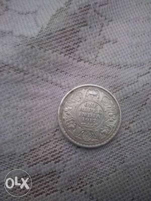It is a silver coin of George v king emperor of