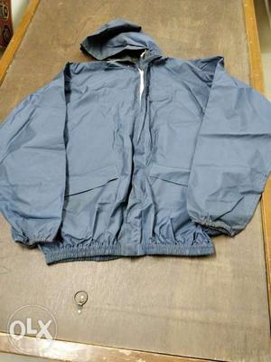 Grey two-piece raincoat for men. In new condition