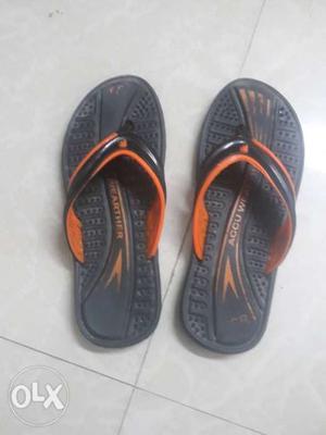 Pair Of Black-and-orange Rubber Flip-flops