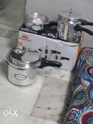 Two Gray Stainless Steel Pressure Cookers