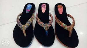 Two Pairs Of Black And Brown Flip Flops