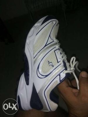 Unpaired White And Blue Nike Running Shoe