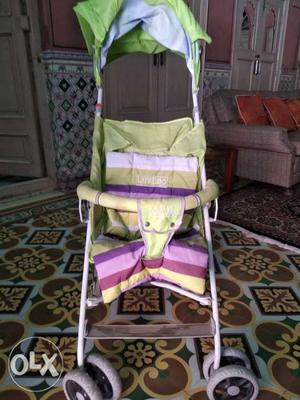 Baby's Green And Pink Stroller