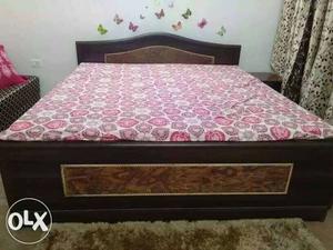 Queen size bed with mattress, pillow and side table.