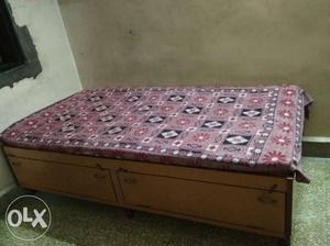 Single wooden bed with large storage capacity, in