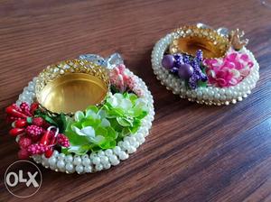 Two Round Gold Candle Holders With Multicolored Flower