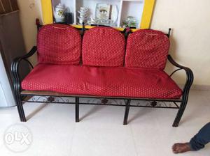 Black Metal Couch With Red Cushions