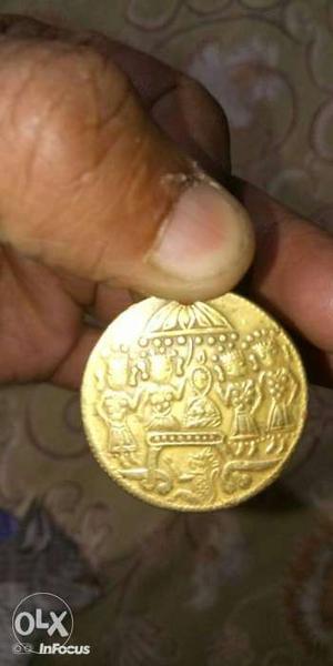 Round gold colored old coin