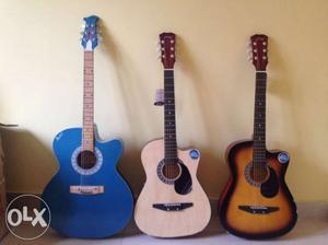 Three Blue And Brown Acoustic Guitars