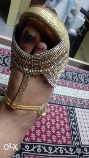 Golden color sparkling sandals used once. Size: 7