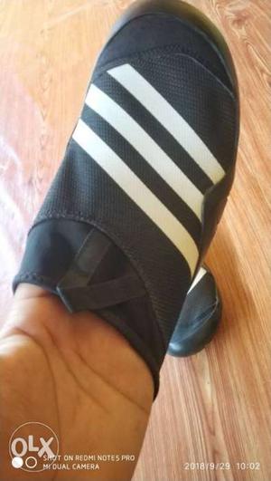 Unpaired Black And White Adidas Slide Sandal