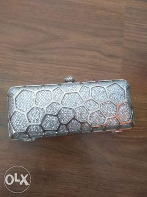 Unused metallic clutch. with a metal chain