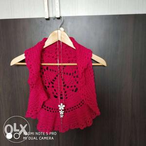 A sleeveless crochet shrug. It's a size XS