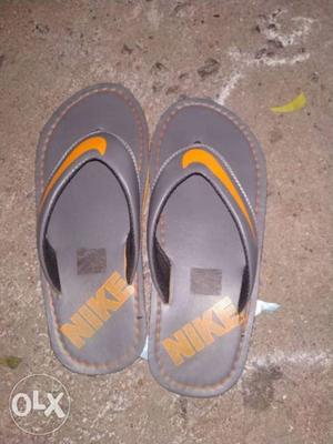 Pair Of Gray-and-yellow Flip Flops
