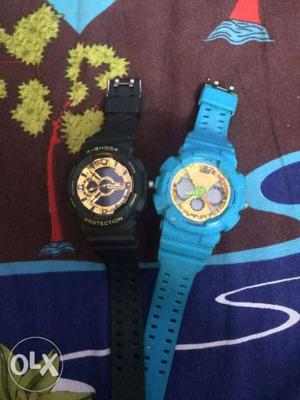 Two Round Black And Blue Digital Watches