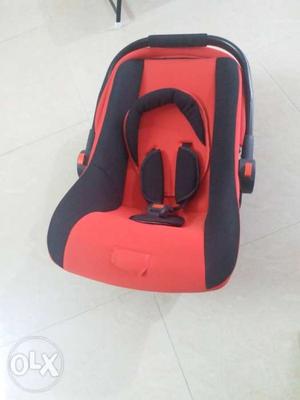Baby's Red And Black Car Seat Carrier and Rocker